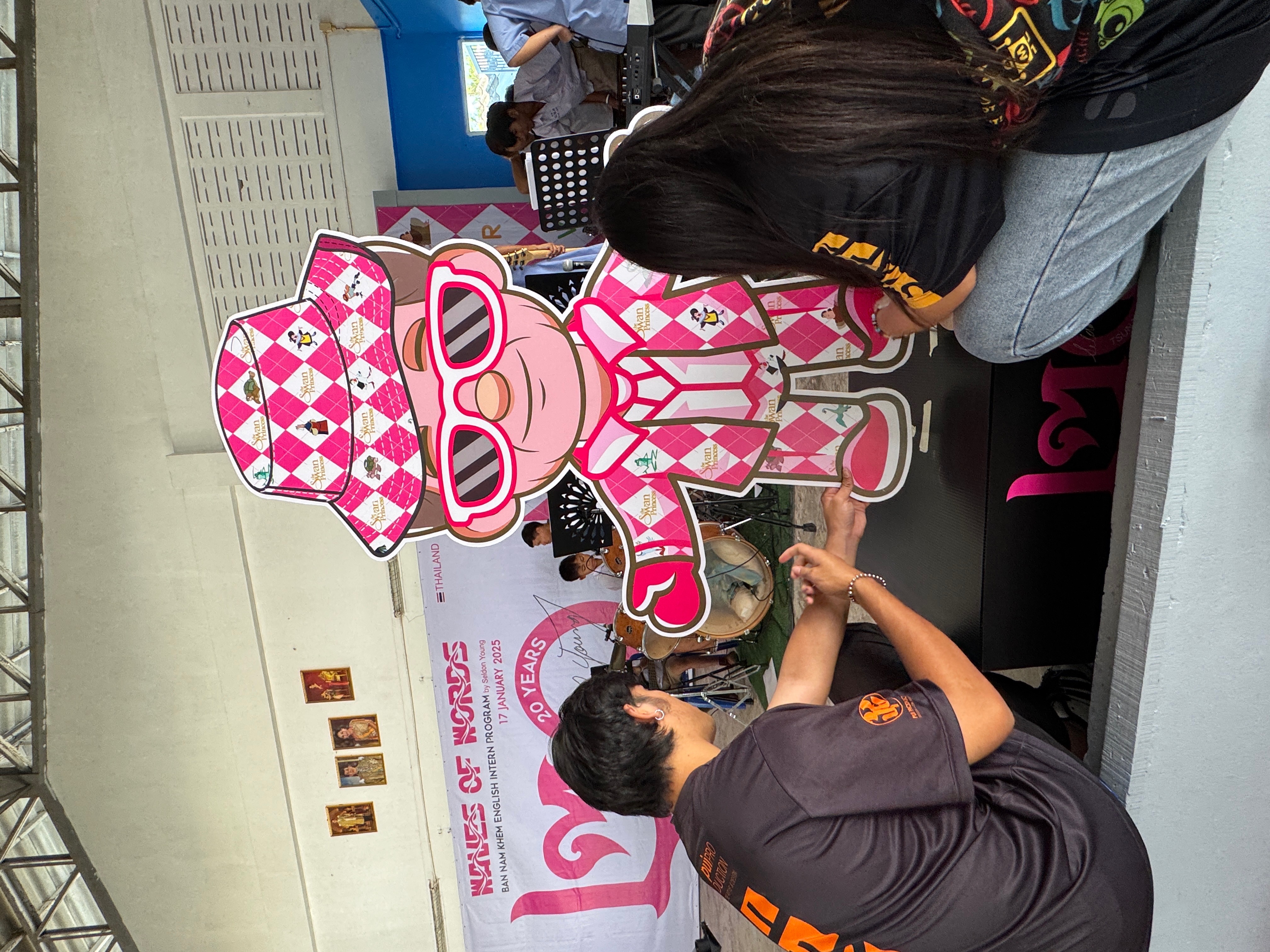 Professor WOW cutout at Bannamkem School, two students greeting