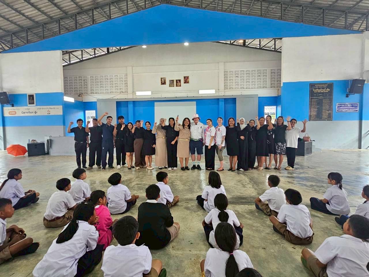 School assembly in a circle with teachers and interns