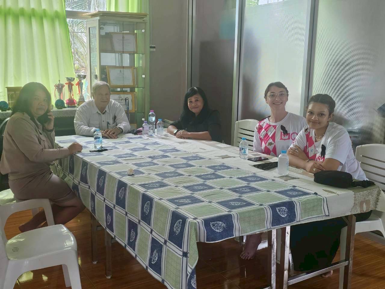 Board meeting around a table with Seldon and interns