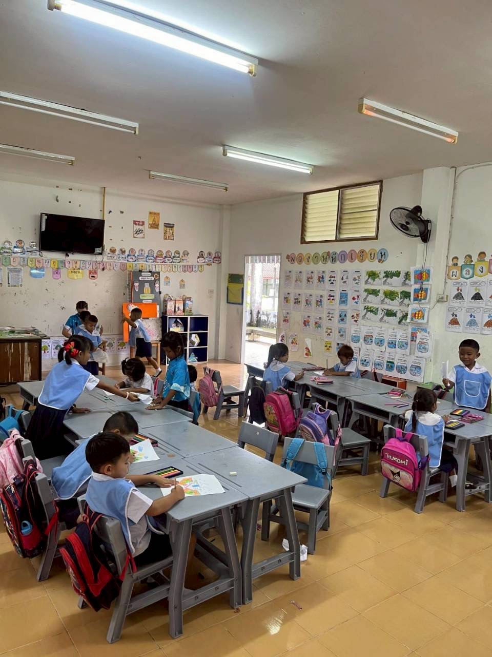 Kindergarten classroom with kids coloring