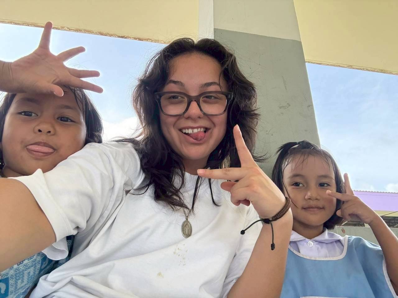 Intern selfie with two young students