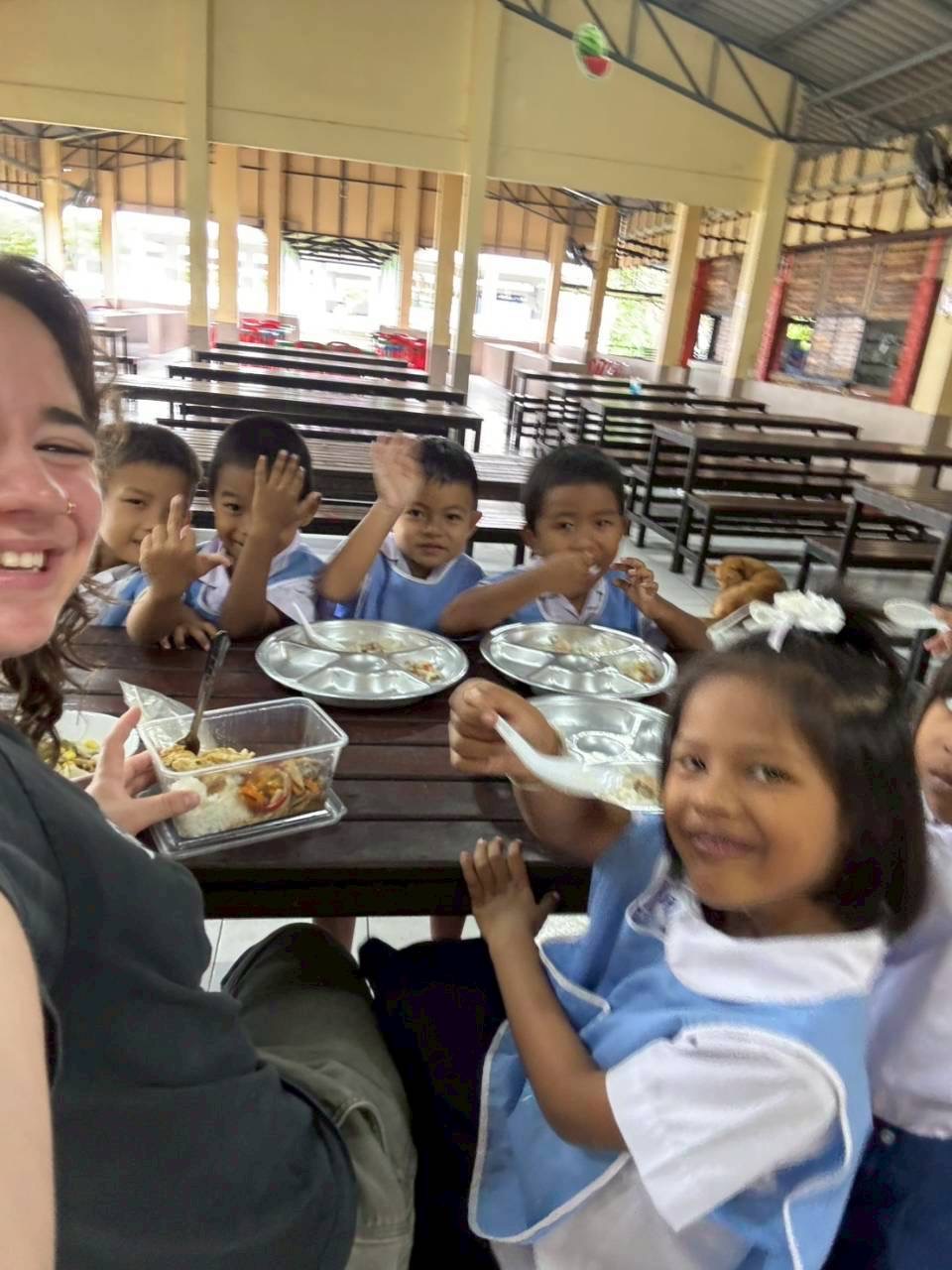 Intern eating lunch with kids in the cafeteria