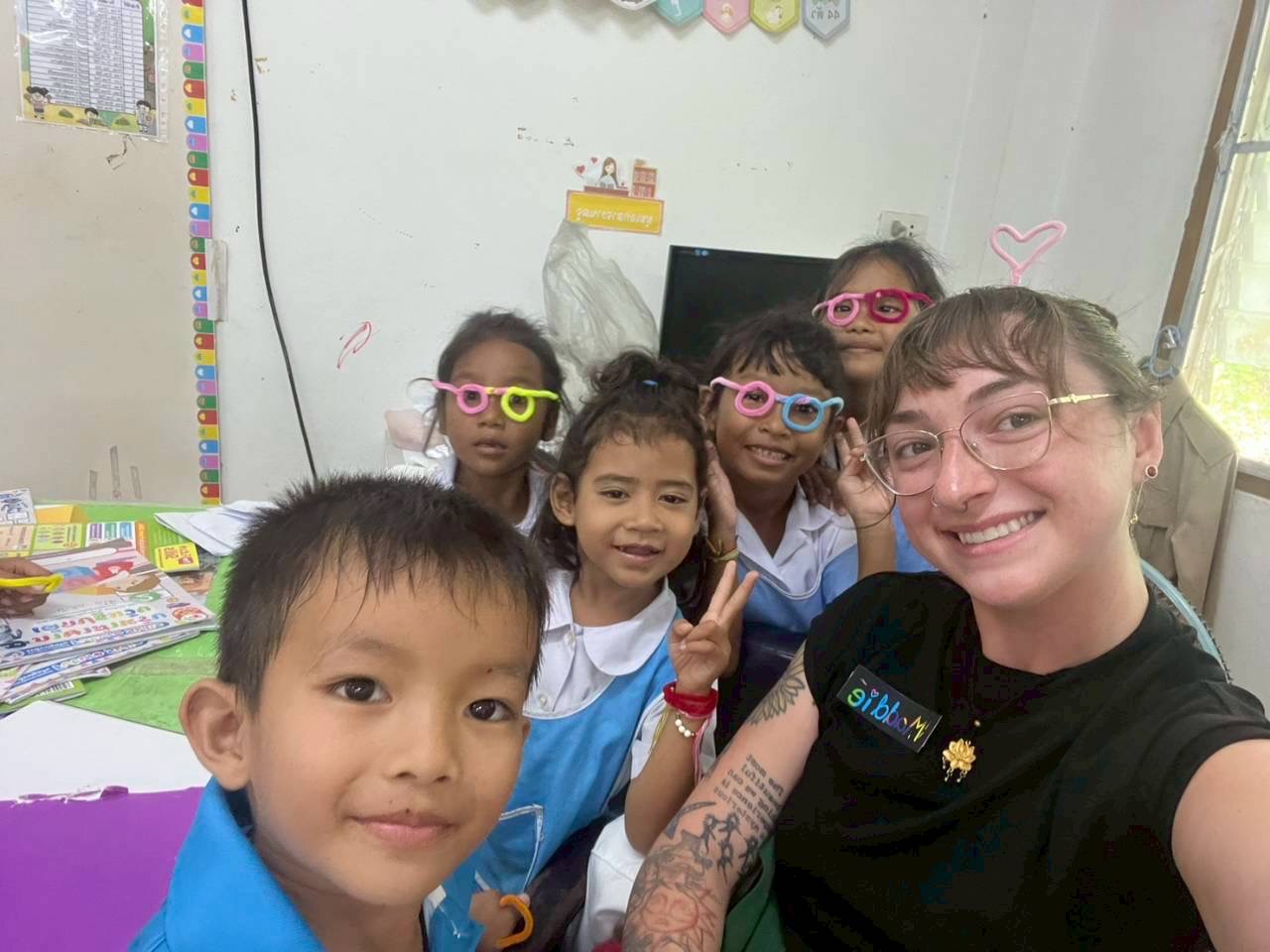 Intern and students wearing novelty glasses