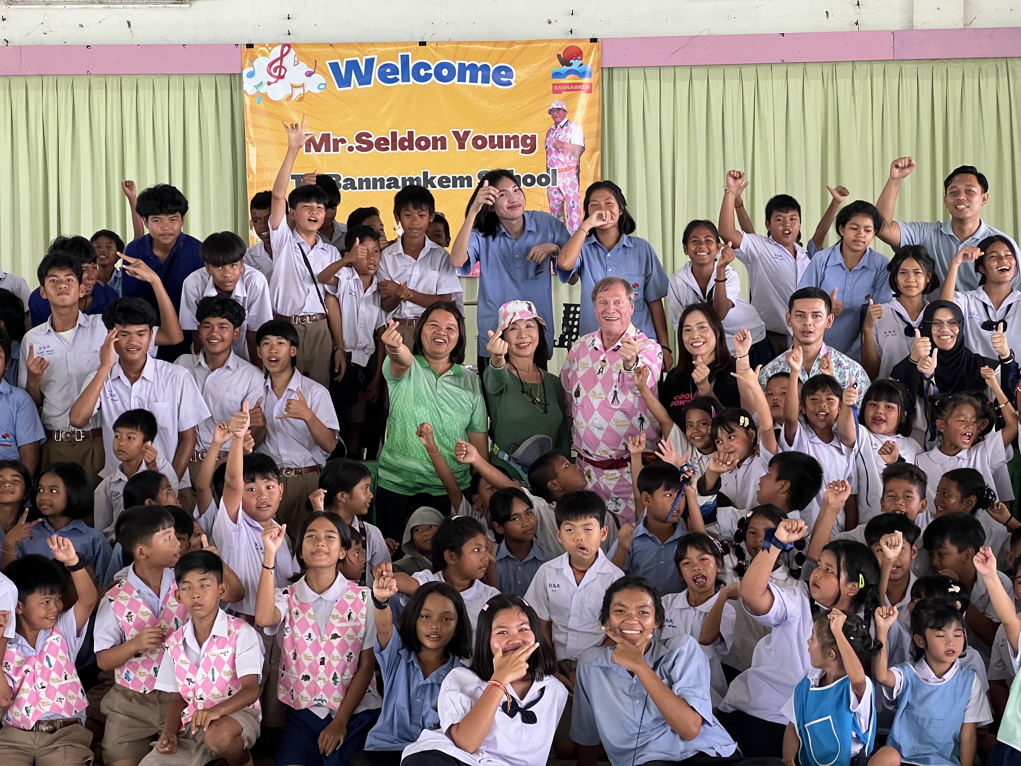 Students cheering with interns at the welcome assembly